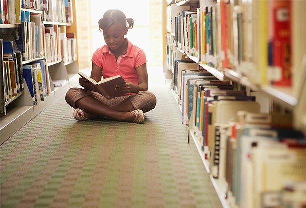 photo: Girl reading at the library (iStockphoto)