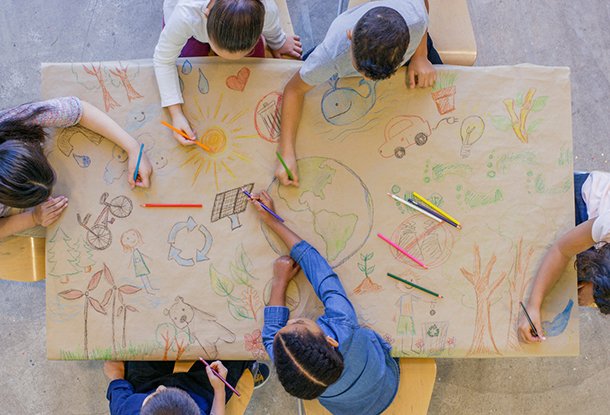 photo: children drawing together on a table
