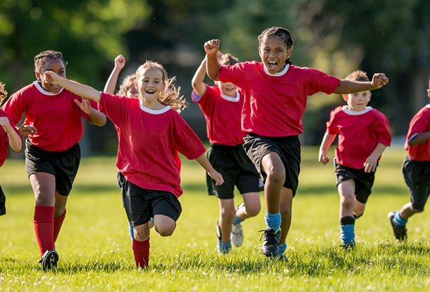 photo: children joyously playing soccer