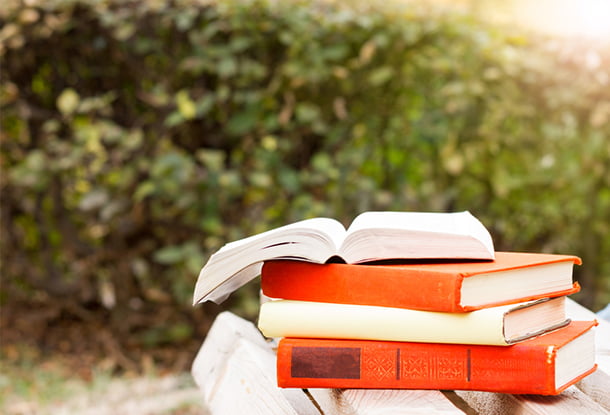 photo: pile of books outside on a nice day (iStockphoto)