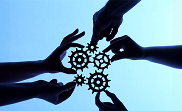 photo: shadows of hands holding cogs (iStockphoto)