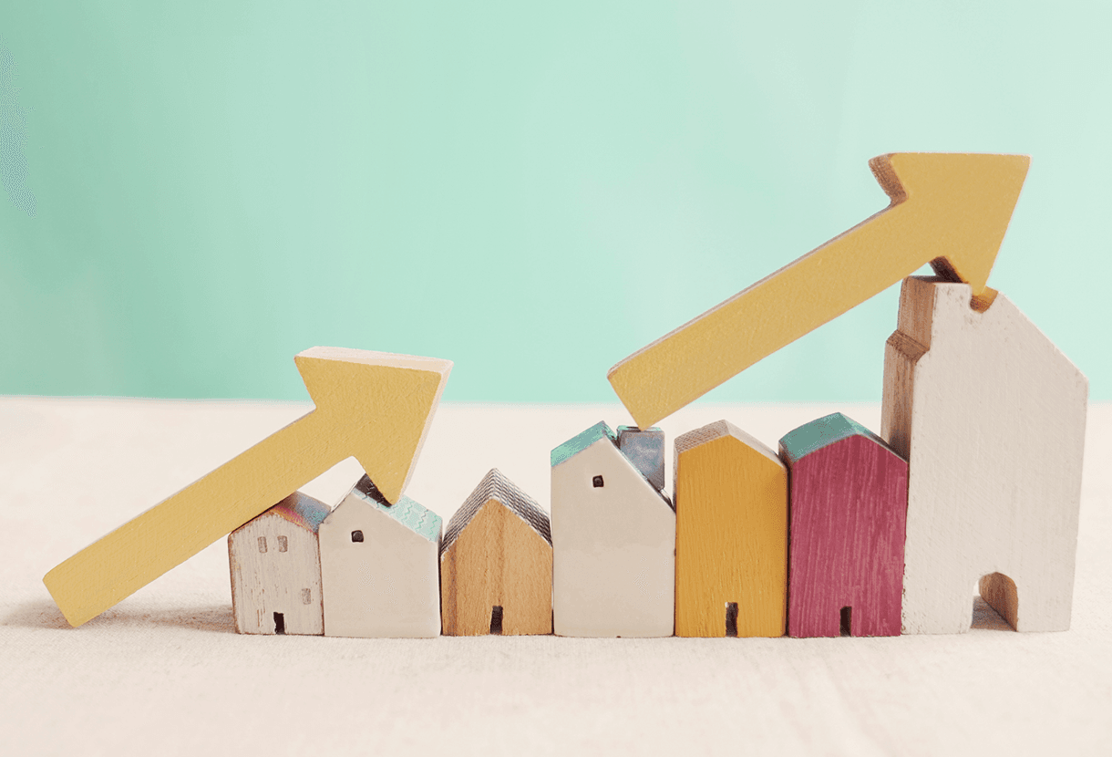 image: Wooden houses with yellow arrows pointing up (iStockphoto)