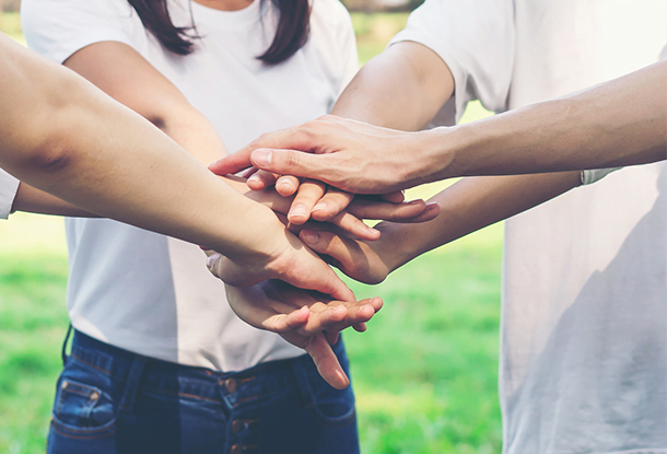 photo: youth stacking hands (iStockphoto)