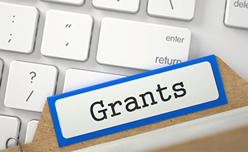 image: keyboard and folder with label "Grants" (iStockphoto)
